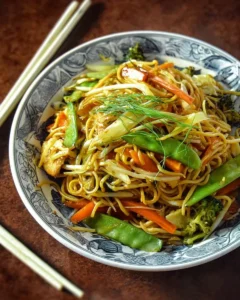Plate of colorful Vegetarian Chow Mein with fresh vegetables and noodles