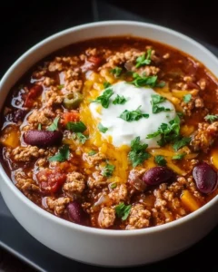 Bowl of award winning turkey chili topped with fresh herbs