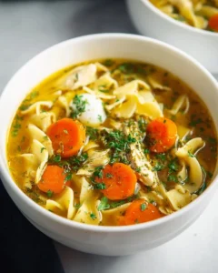 Bowl of homemade chicken noodle soup with egg noodles and fresh vegetables