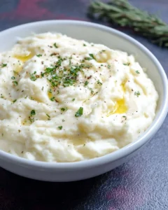 Bowl of creamy Southern mashed potatoes with butter and herbs