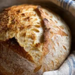 Freshly baked sourdough bread on a wooden cutting board