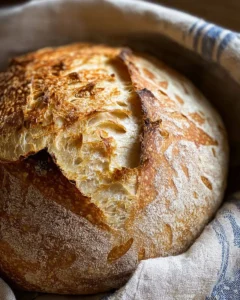 Freshly baked sourdough bread on a wooden cutting board