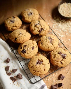 Freshly baked Coconut Chocolate Chip Cookies with milled flour on a wooden table