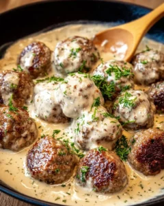 Delicious homemade Swedish meatballs served with creamy sauce and lingonberry.