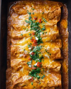 Delicious home-cooked beef enchiladas topped with melted cheese and fresh ingredients.