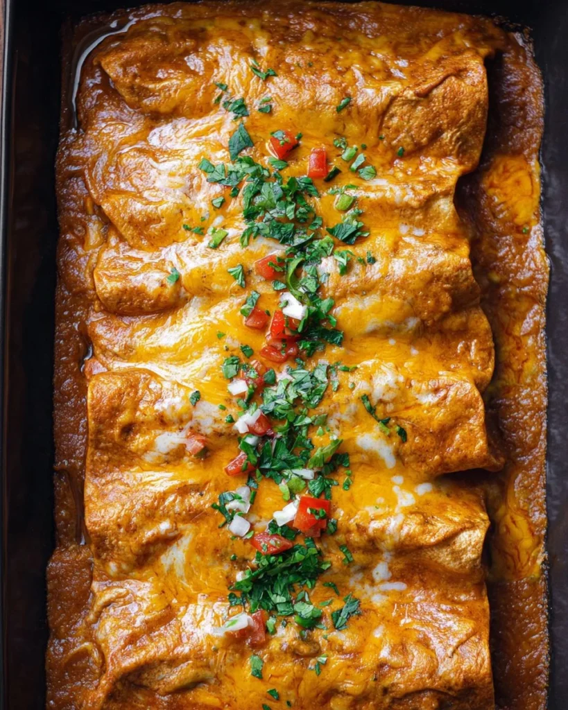 Delicious home-cooked beef enchiladas topped with melted cheese and fresh ingredients.