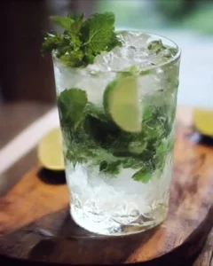 Homemade mojito cocktail with mint, lime, and sugar served in a glass