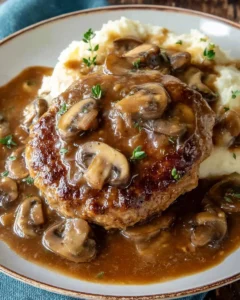 Turkey Salisbury Steaks served with rich mushroom gravy on a plate