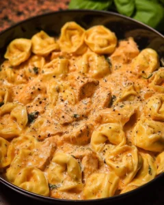 CrockPot Chicken Tortellini served in a bowl, showcasing creamy sauce and fresh ingredients.