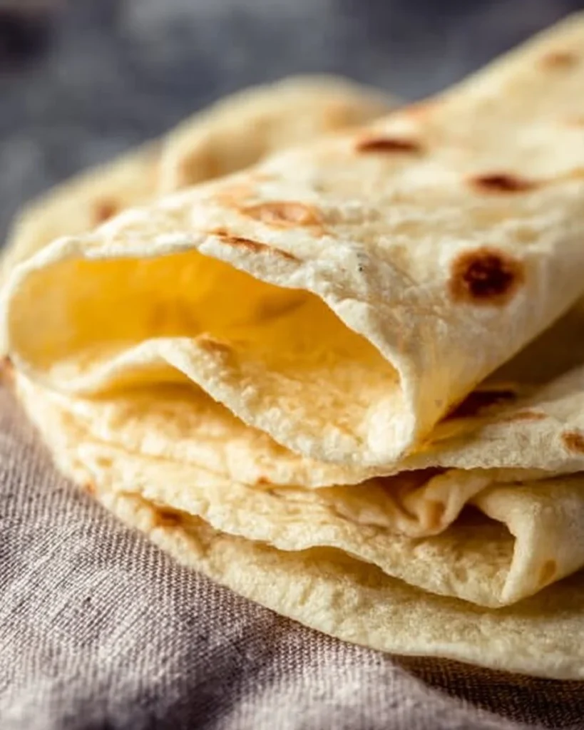 Homemade easy flour tortillas on a wooden table