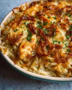 Delicious French onion chicken orzo casserole topped with melted cheese and caramelized onions