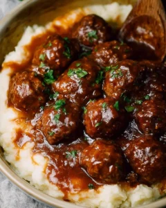 Slow Cooker Salisbury Steak Meatballs served on a plate with gravy and sides