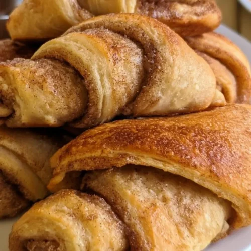 Air fryer cinnamon crescent rolls drizzled with cream cheese glaze