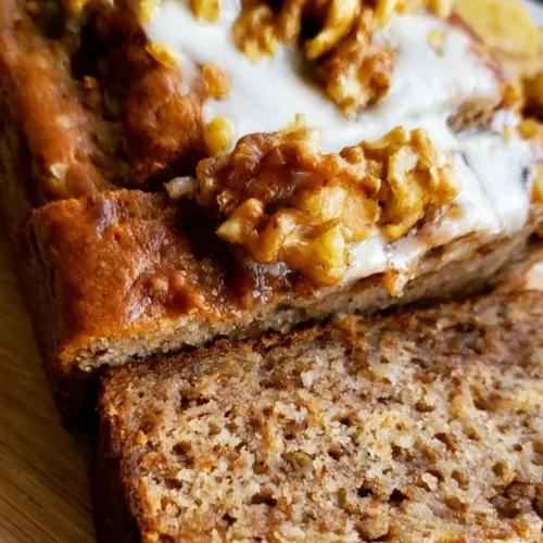 Banana Walnut Bread with Cream Cheese Frosting 2 Delicious banana walnut bread slice with walnuts on a plate