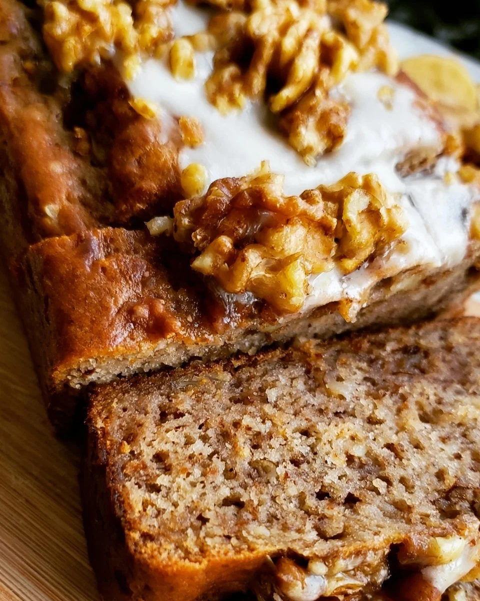 Banana Walnut Bread with Cream Cheese Frosting 3 Delicious banana walnut bread slice with walnuts on a plate