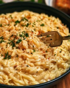 Creamy garlic parmesan orzo served in a bowl with fresh herbs