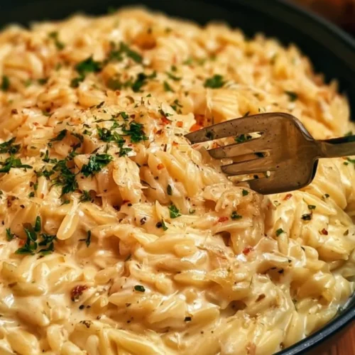 Creamy Garlic Parmesan Orzo 2 Creamy garlic parmesan orzo served in a bowl with fresh herbs