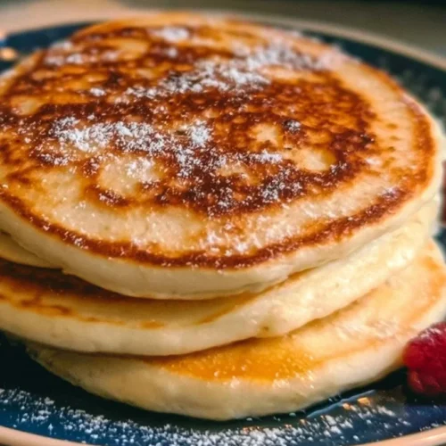 Fluffy Pancakes 3 Stack of fluffy pancakes topped with butter, syrup, and fresh berries