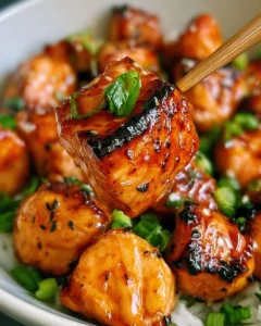 Delicious miso air fryer salmon bites served on a plate with garnishes