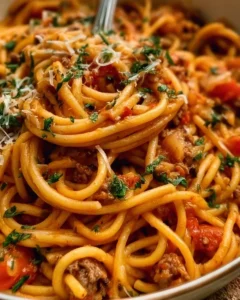 Delicious one pot taco spaghetti served in a bowl with fresh toppings.