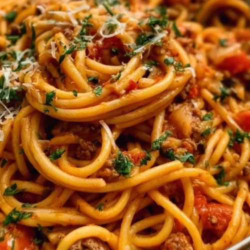One Pot Taco Spaghetti 3 One pot taco spaghetti with ground beef, melted cheese, and fresh cilantro in a bowl