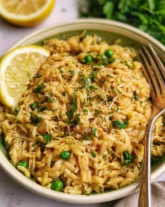 Plate of quick lemon orzo pasta garnished with herbs