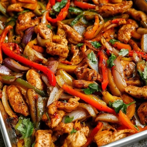 Sheet-Pan Chicken Fajitas 3 Sheet-pan chicken fajitas with roasted peppers and onions on a baking sheet