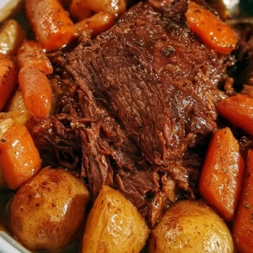 Slow cooker pot roast with carrots and potatoes on a platter